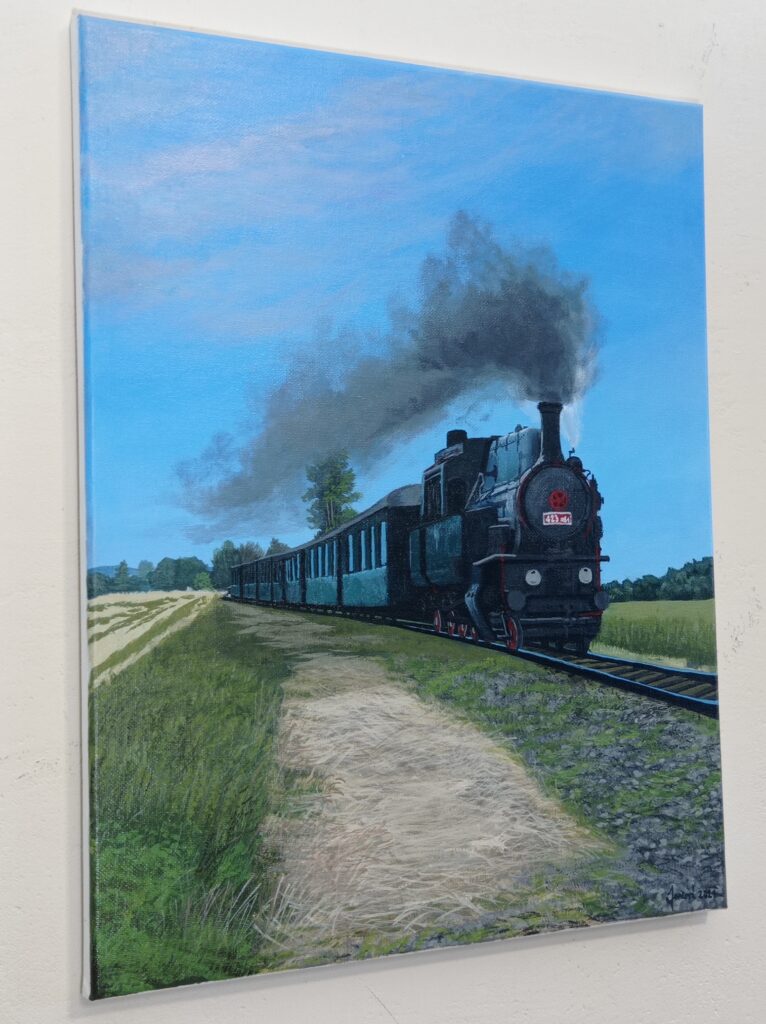 Obraz vlaku zavěšený na zdi.